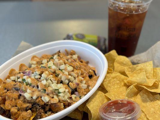 Mexican Rice(just 1 scoop), black beans, bacon, Baja chicken, Queso, corn salsa, and chipotle aioli with chips and salsa.