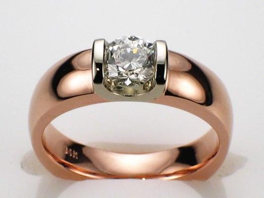 14 karat Rose Gold saddle ring with 0.56 carat round brilliant diamond in platinum saddle.