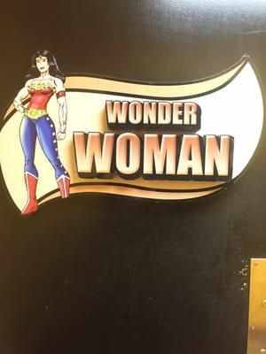 Toilets are labeled as Wonder Woman and Super Man