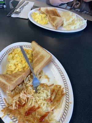 Scrambled eggs , toast, hash brown and grits