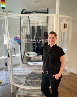 Lead doctor, Dr. Alicia Brown standing in front of the GyroStim therapy device.