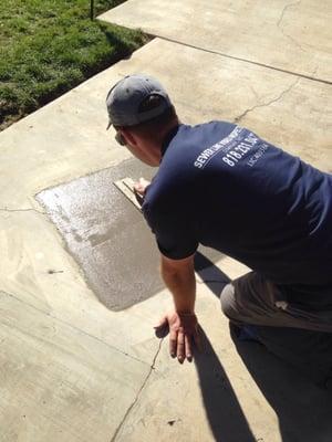 Patching concrete after sewer replacement.