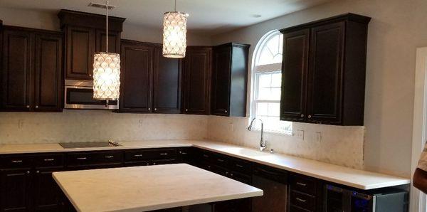 Solid surface countertops with full wall splash..