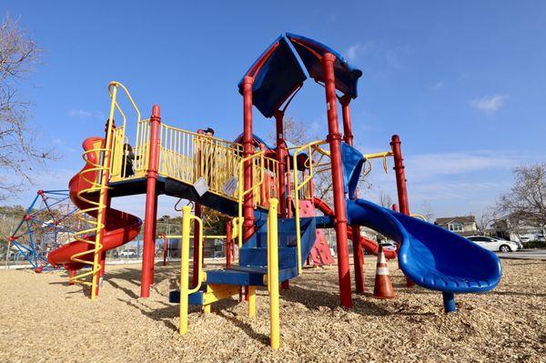 The backside of the bigger play structure has smaller slides that aren't as steep.