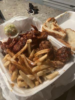 Delicious Turkey tip and Wing Combo with mild sauce, bread, and coleslaw