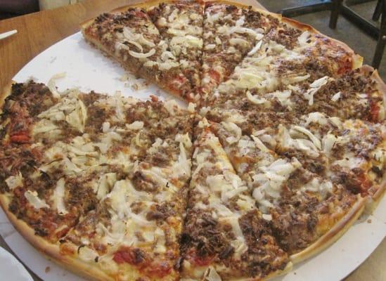 Large hamburger and onion pizza.