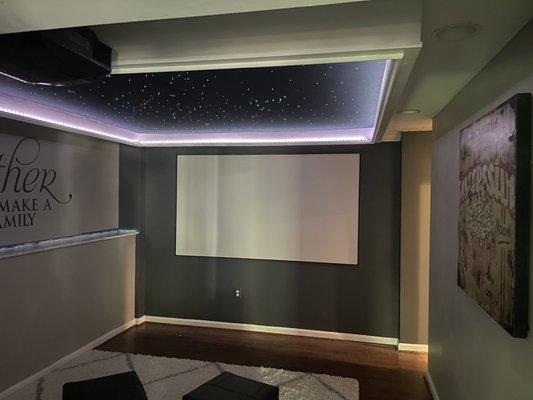 Color under glow light, starfield ceiling. 100" screen