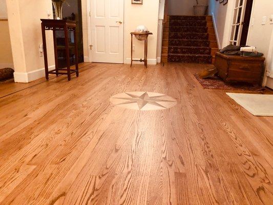 Existing hardwood floor refinished. New medallion added.