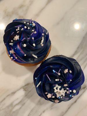 Custom galaxy inspired frosting on chocolate and vanilla cupcakes. Sprinkles are by Supernatural.