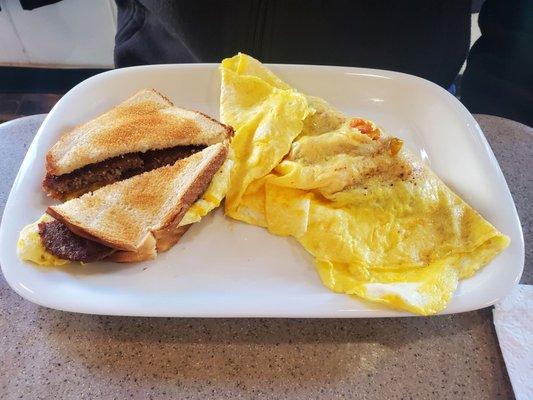 Omelet and sausage breakfast sandwich