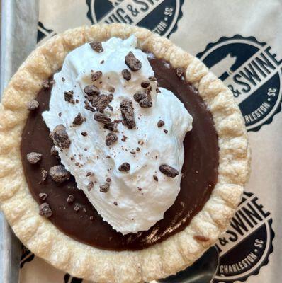 Chocolate Pudding Pie with homemade whipped cream sprinkled with chocolate chips.