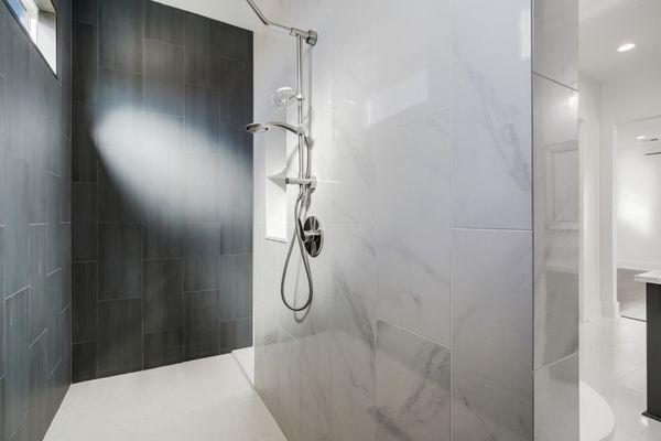 Wrap around walk through shower with transoms, marble & slate walls