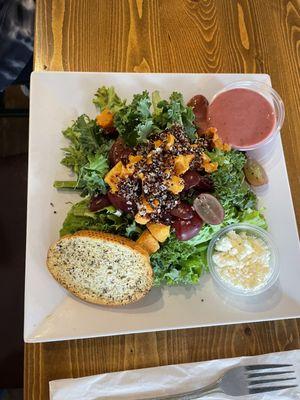 Kale Mixed Green Salad - roasted sweet potatoes, grapes, cranberries, quinoa, feta, had berry balsamic vinaigrette with it.