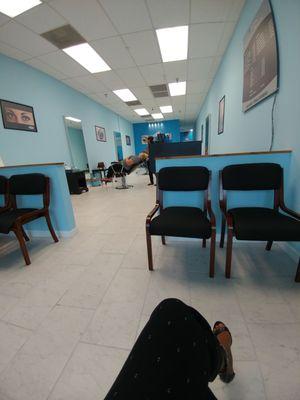 Spacious area with 6-8 chairs in waiting area. Clean decor