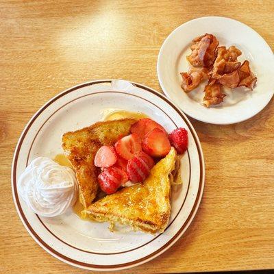 Creme' Brûlée french toast (mascapone is under the french toast) with fresh strawberries and crispy bacon.