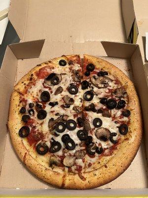 Small gluten free crust pizza with mushrooms and black olives