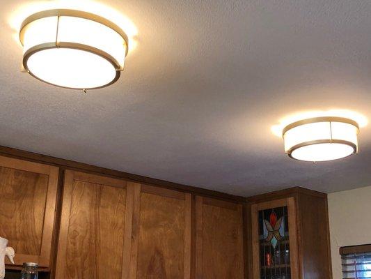 Satin brass and white flush mount ceiling lights.