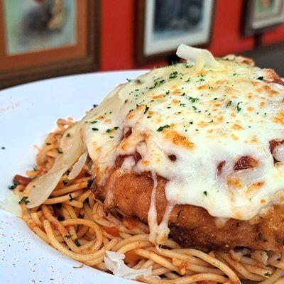 Chicken Parmesan over a bed of spaghetti with our new Marinara Sauce 
comes with a side salad for $13.95