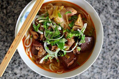 Bun Bo Hue ( spicy beef, pork blood, pork feet, tendon, steamed pork, noodle, green onion, white onion and cilantro )