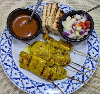 Chicken skewers marinated in coconut milk and spices then grilled and served with a peanut sauce and cucumber relish