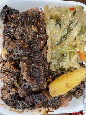 Fadda's oxtails with rice and peas with cabbage and plantain.