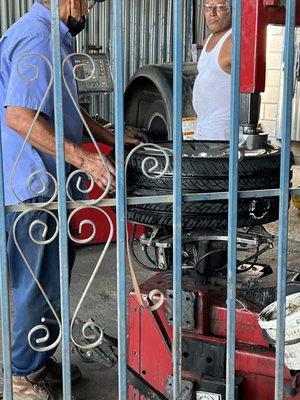 Tire Technicians fixing my tire with screw hole.