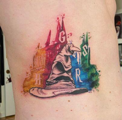 Harry Potter sorting hat with watercolor Hogwarts castle.