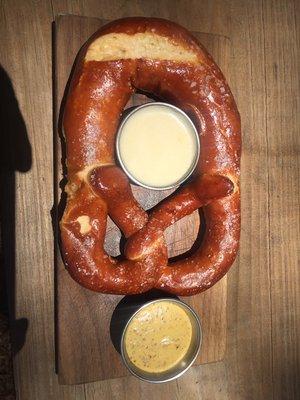 Freshly baked pretzel with beer cheese fondue and spicy mustard