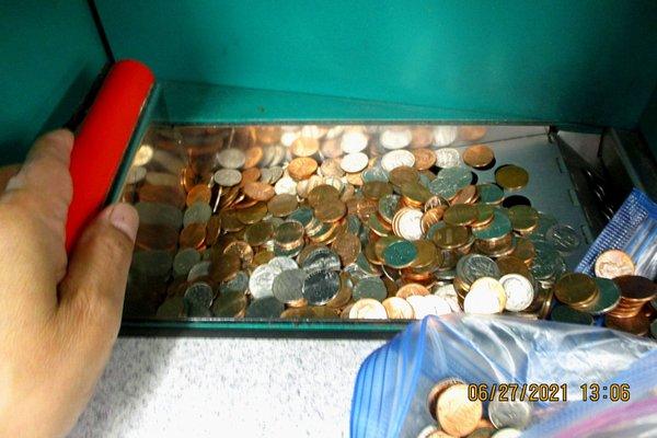 Placing my coins in tray.