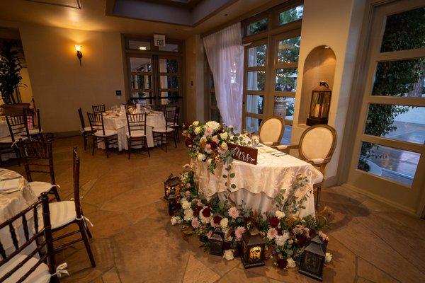 Sweetheart table - ceremony florals were repurposed.