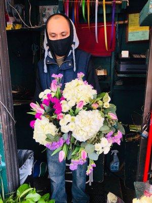 Juan working on my customized flower arrangements using the flowers available in the shop