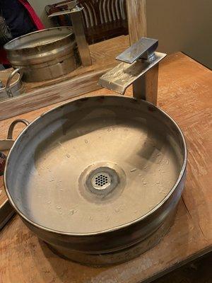 Sink in the restroom made out of a keg