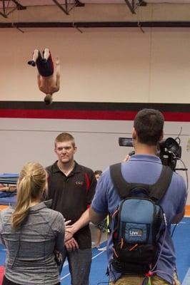 Fox News interviewing Coach JJ Ross as Regional Qualifier Zac - Level 10 Gymnast here at CGC training in the background.