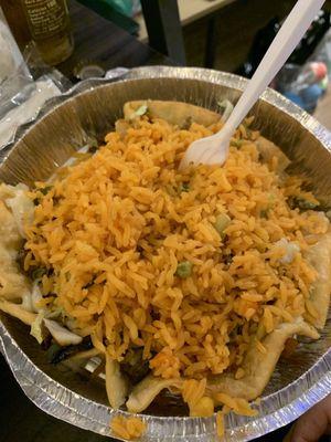 Taco salad with a side of rice.