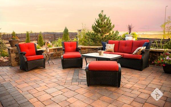 Paving stone patio with a custom paver design, paver sitting wall and pillars.