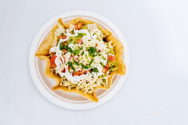 Taco Salad: Hard shell bowl, choice of meat, black beans, lettuce, tomato, cheese and sour cream.