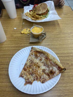 Pizza and chicken sandwich with fries and cheese.