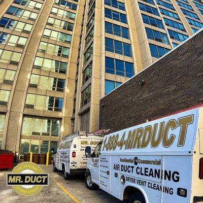 Mr. Duct trucks outside of a commercial air duct cleaning job site in Chicago.