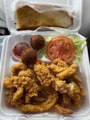 Seafood plate. Got extra catfish instead of oysters. I think that shredded lettuce and tomato slice is the "salad"