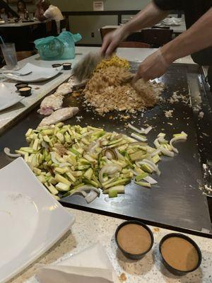 Londy cooking our rice noodles and vegetables.