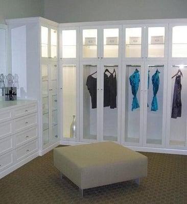 Walk in Closet with custom dresser & glass door inserts to show off your wardrobe