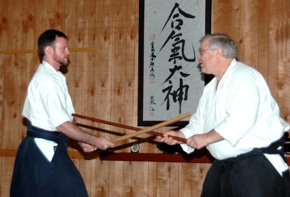 Sword and staff work are integral to Aikido training.