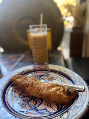 Oat milk latte and ham and cheese croissant pastry