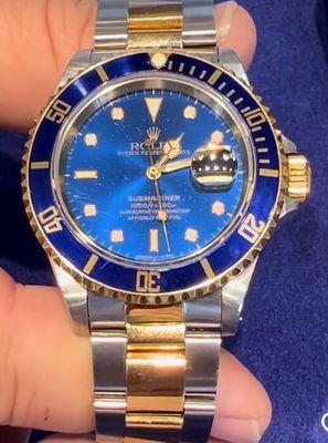 Blue Submariner pre-owned Rolex. We have a large selection of pre-owned Rolexes, often with their original packaging and paperwork.