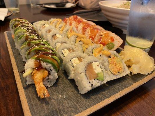 Four (4) types of sushi are shown. (L to R) Green Dragon, Philly (Philadelphia), Spicy California, and Boston rolls.