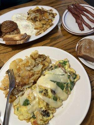 First dish- veggie omelette with home fries.  Second dish-egg breakfast, side of toast and a side of bacon.