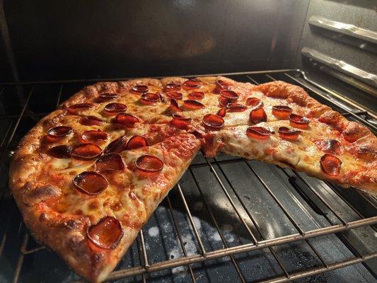 Underdone pizza, back into the oven at home