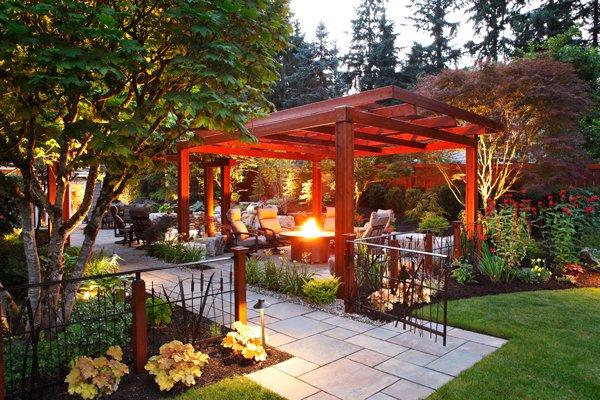 Custom pergola and fire pit surrounded by beautiful stone work.