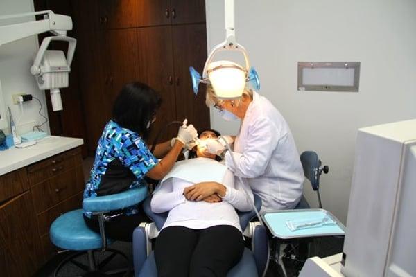 Dentist, Dr. Carol E. Follette, works on a patient in Santa Monica, CA.