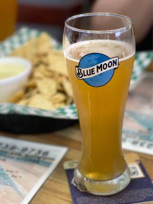 Chips and Queso paired with a Blue Moon.